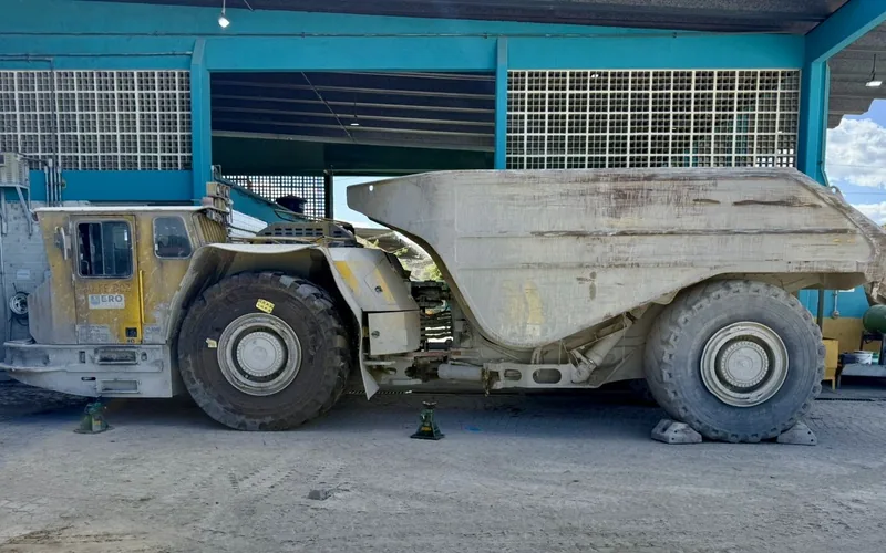 Underground haulage truck standing in a mine workshop bay